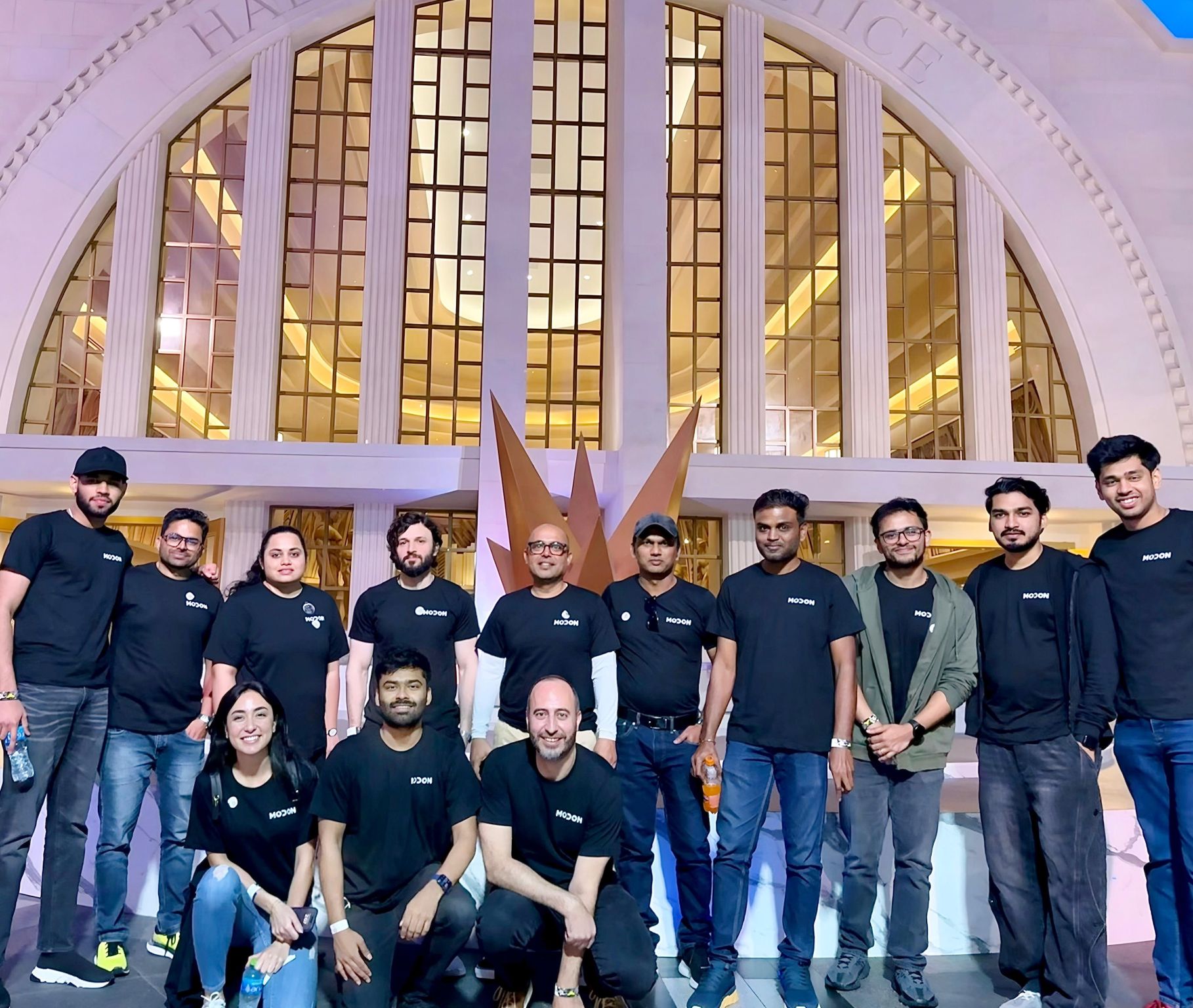 Modon team in black Modon T-shirts, group photo